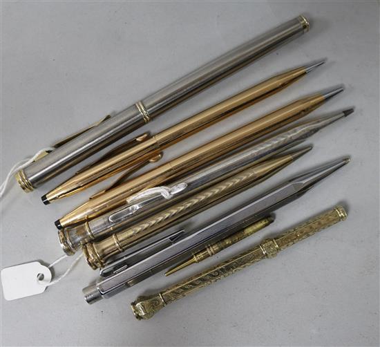 A group of pens and pencils, including a gold encased propelling pencil